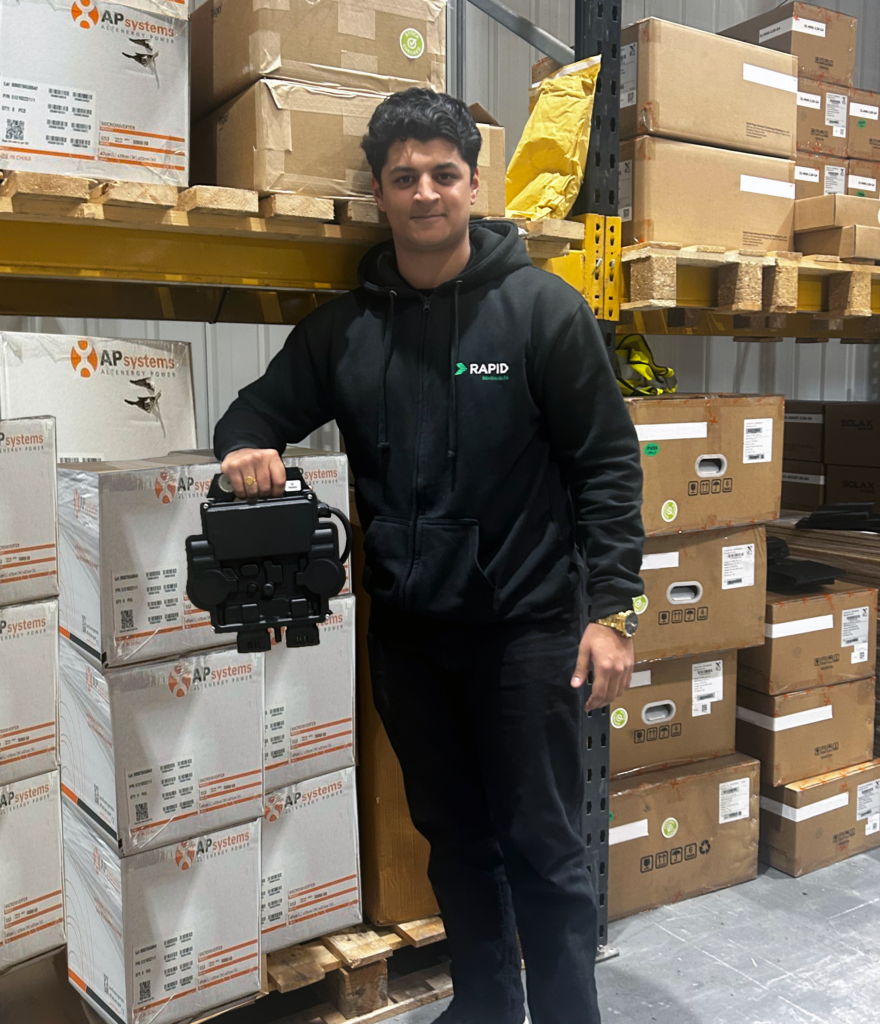 Nikhil from our sales team in the warehouse, displaying the micro-inverters from APsystems. 